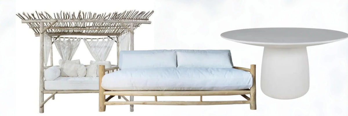 Coastal-style wooden daybed with white cushions, rattan canopy, and modern pedestal table