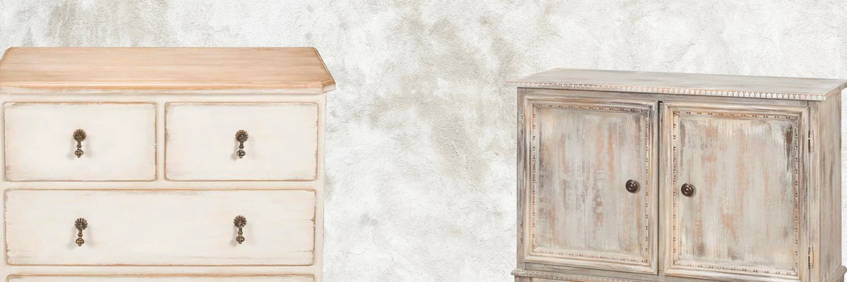 Two shabby chic distressed wood dressers in cream and grey tones against a textured wall.