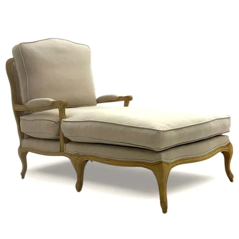 Elegant French country chaise lounge with cream upholstery and carved wooden legs