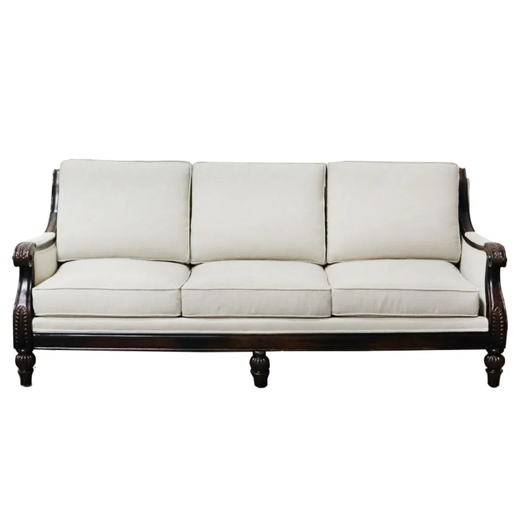 Elegant French country sofa with carved dark wood frame and cream upholstery, perfect for farmhouse or shabby chic decor