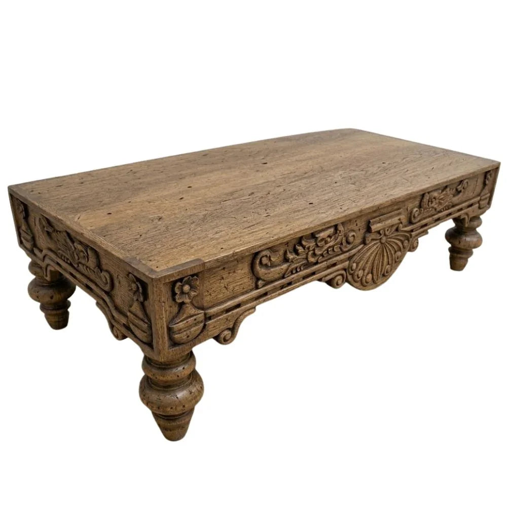 Hand-carved rustic wood coffee table with ornate floral details, perfect for French country or farmhouse decor.