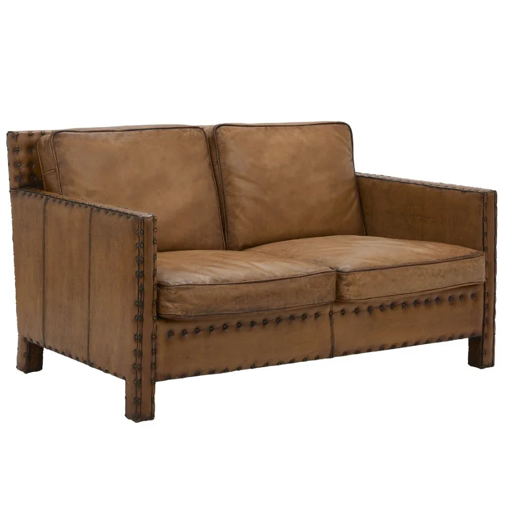 Brown leather loveseat with nailhead trim, rustic farmhouse style seating