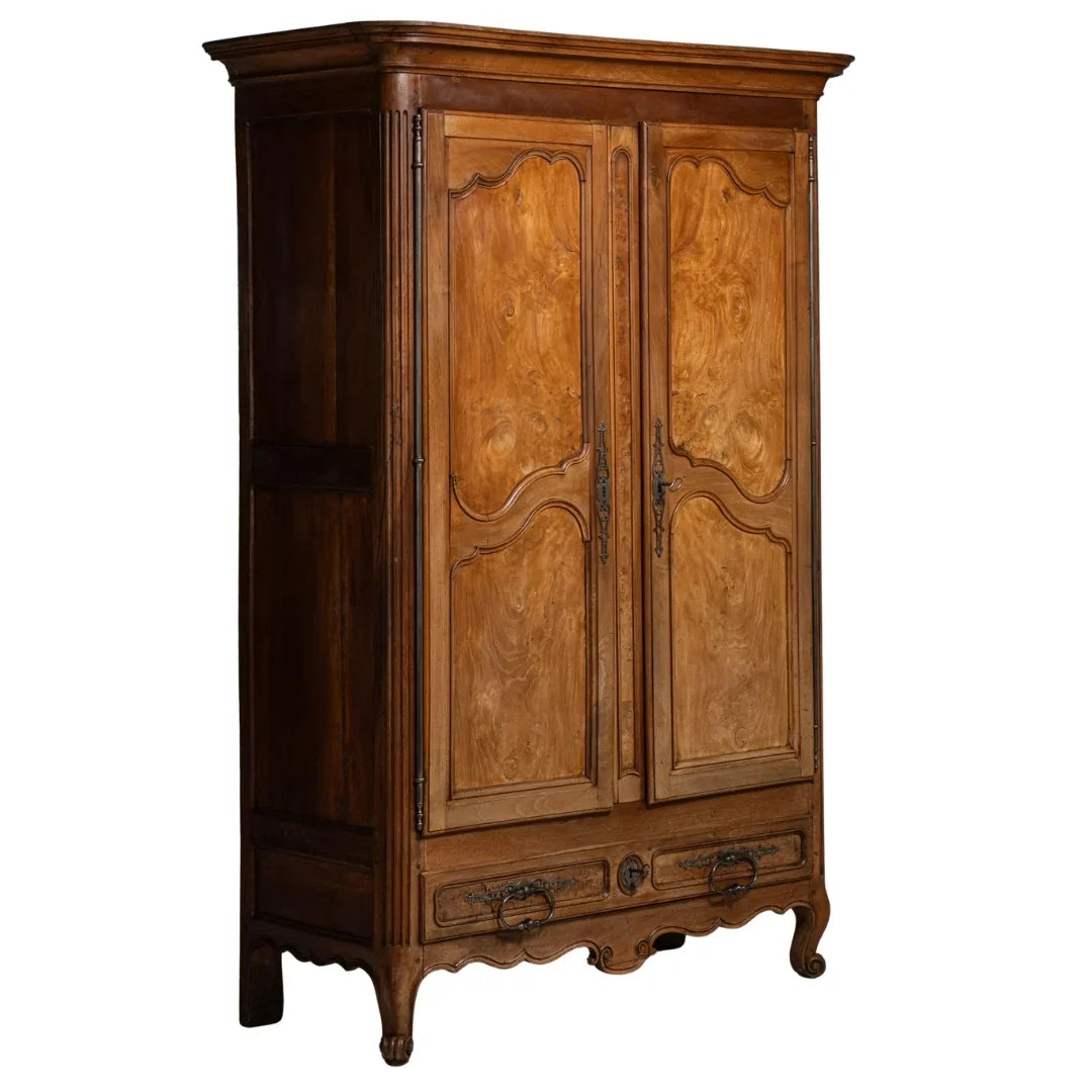 French country armoire with ornate wood detailing and vintage hardware