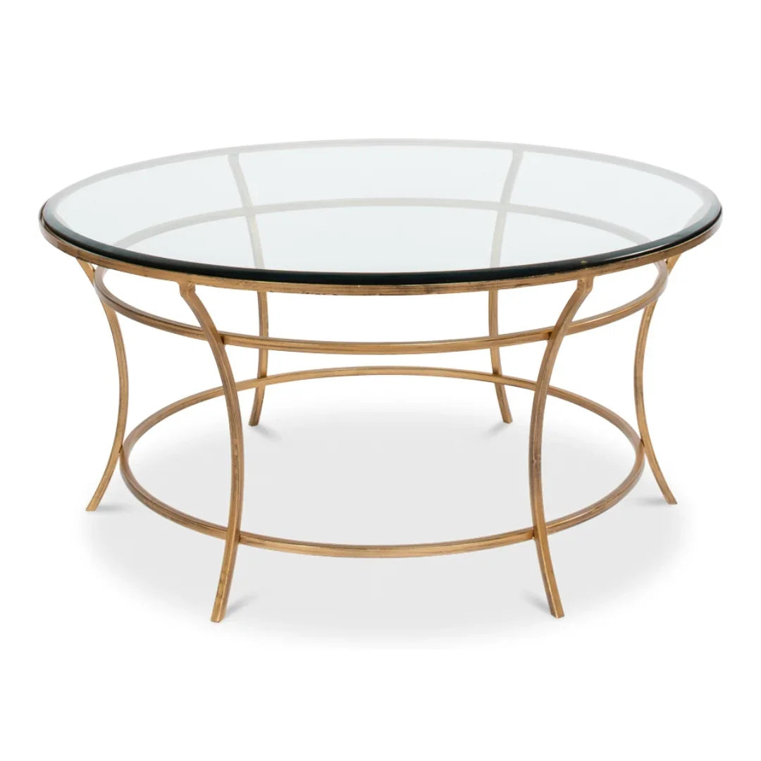 Elegant round glass-top coffee table with gold metal frame, perfect for French country or coastal decor styles.