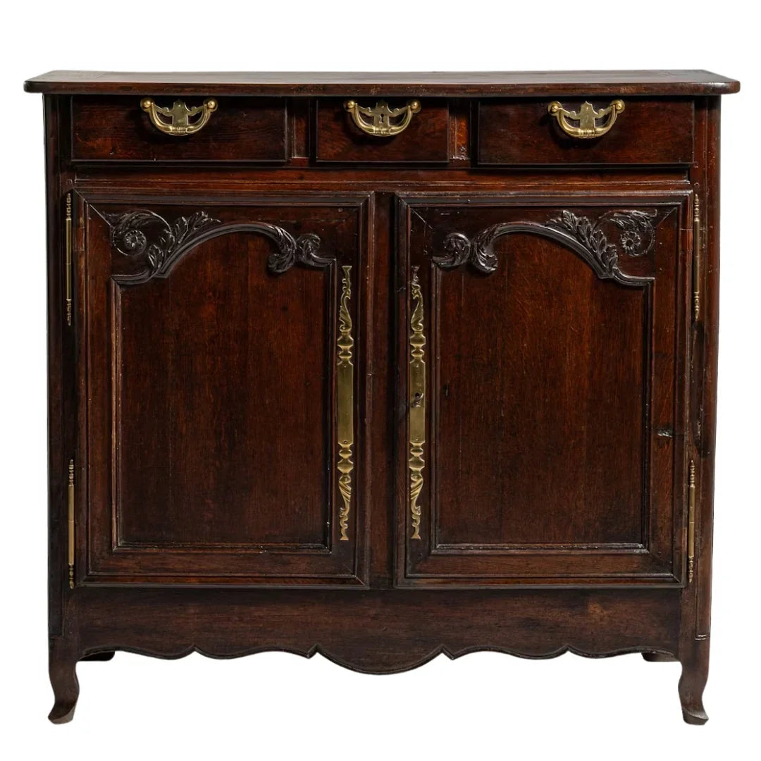 Antique French country cabinet with ornate carvings and brass hardware
