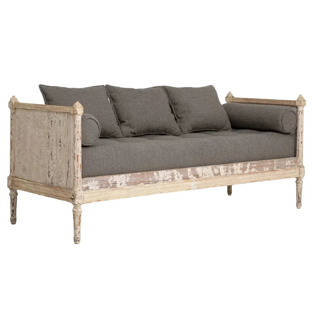 Shabby chic sofa with distressed white frame and gray cushions