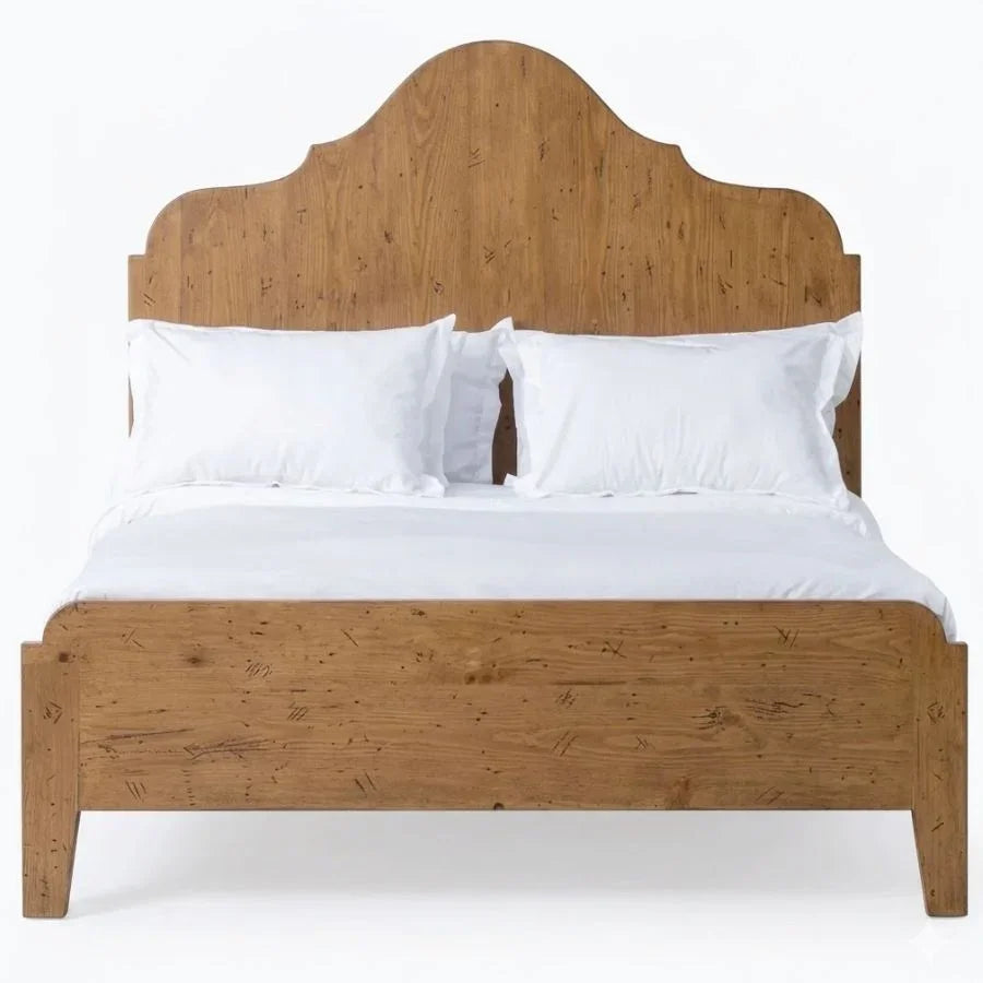 Rustic oak bed frame with arched headboard, white linens, farmhouse style bedroom furniture