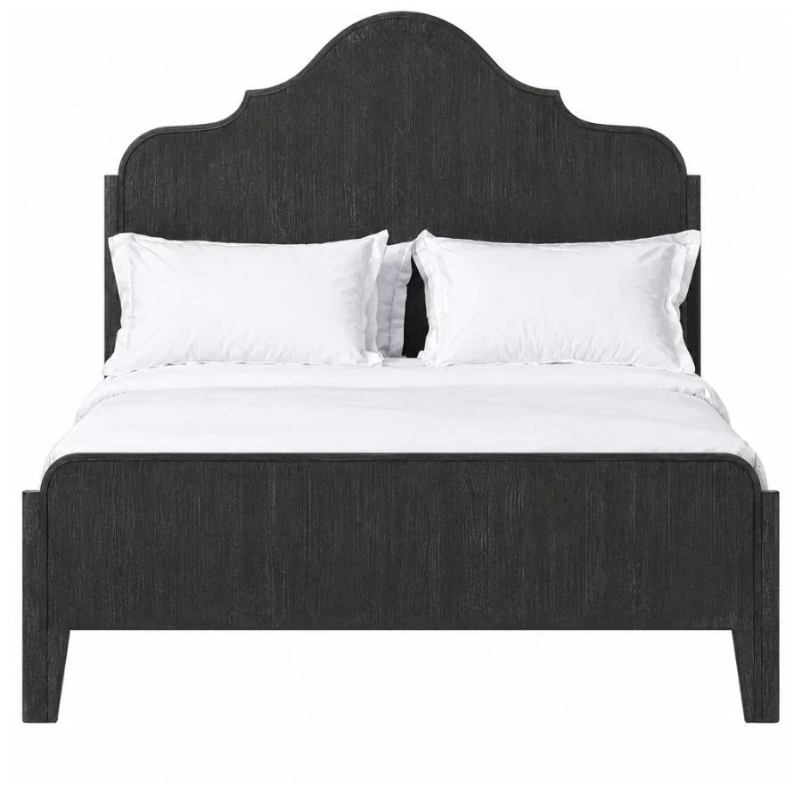 Dark wood farmhouse bed frame with arched headboard and white bedding