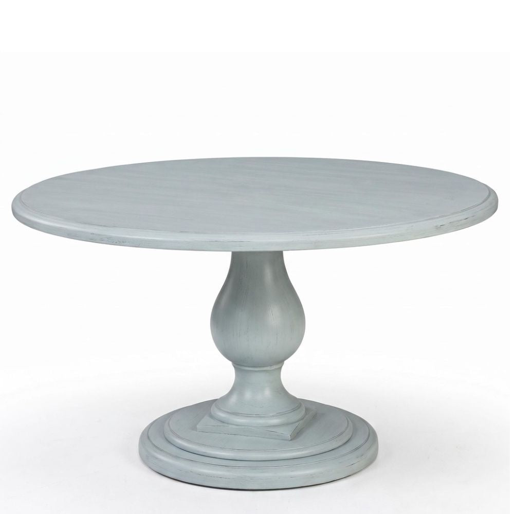 A round pedestal dining table with a distressed light blue-gray finish, shown against a plain white background.