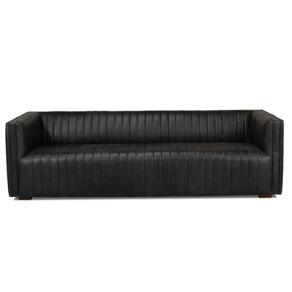 Black leather sofa with vertical channel tufting and wooden legs, modern farmhouse style