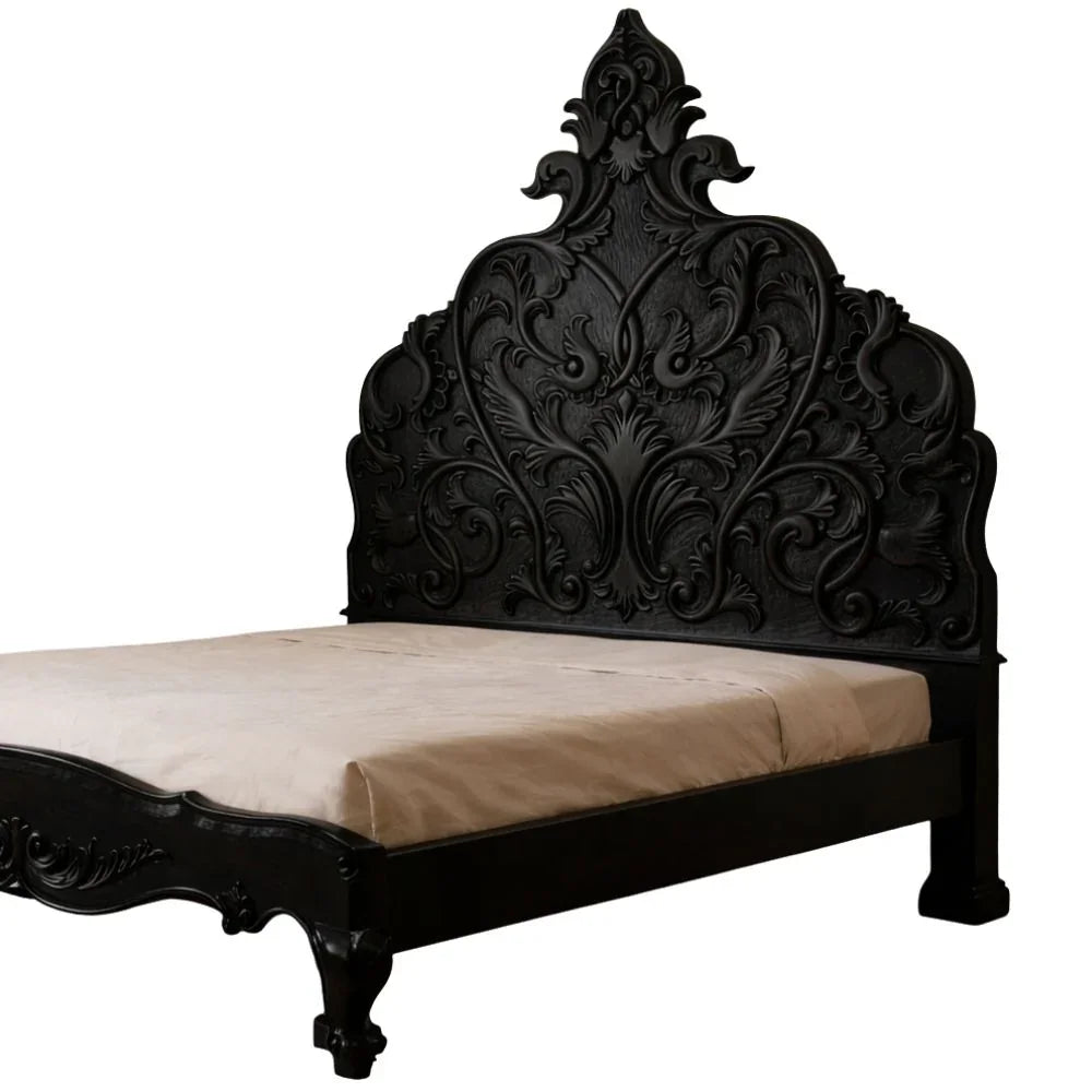 Elegant black ornate bed frame with intricate carvings, perfect for French country or shabby chic decor