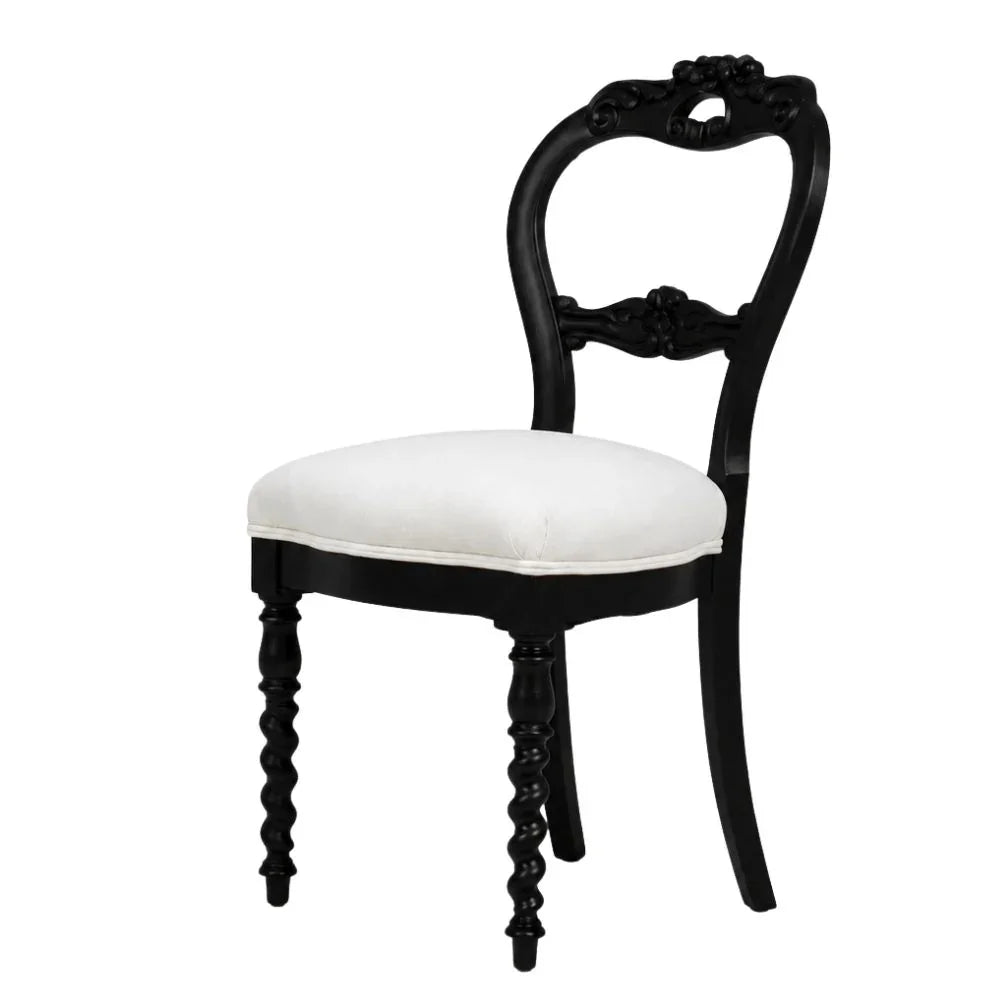 Black ornate French country dining chair with white upholstered seat and carved details