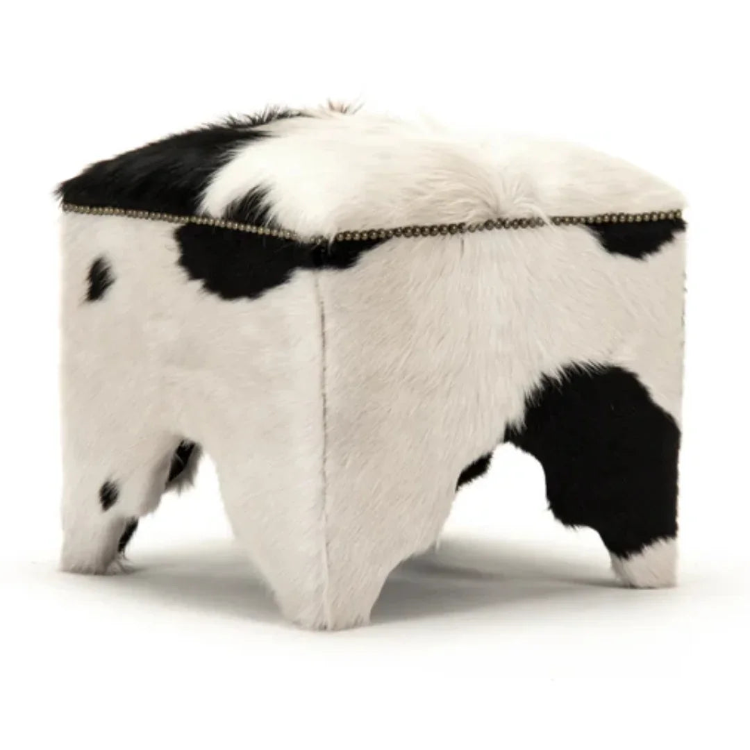 Black and white cowhide ottoman with nailhead trim, natural boho farmhouse style accent piece