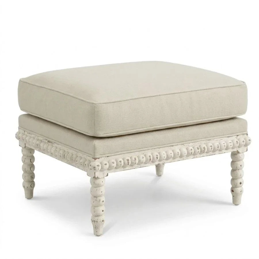 Shabby chic ottoman with distressed wood legs and beige cushion