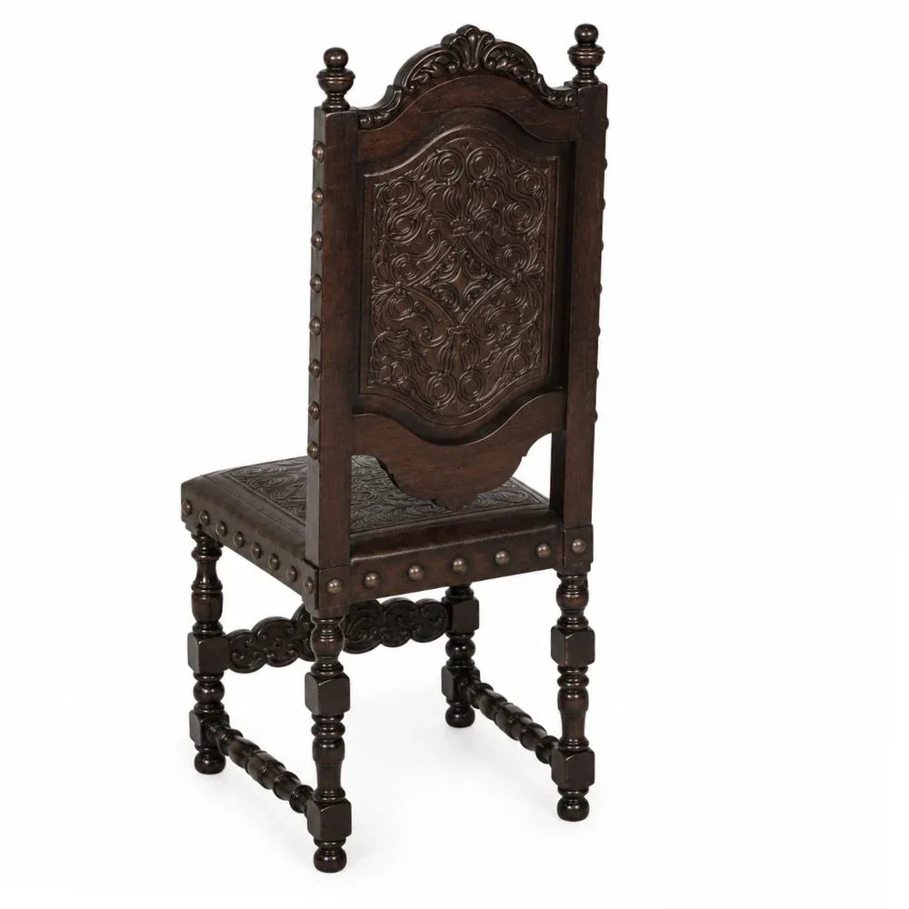Ornate dark wood dining chair with carved back and turned legs, French country style