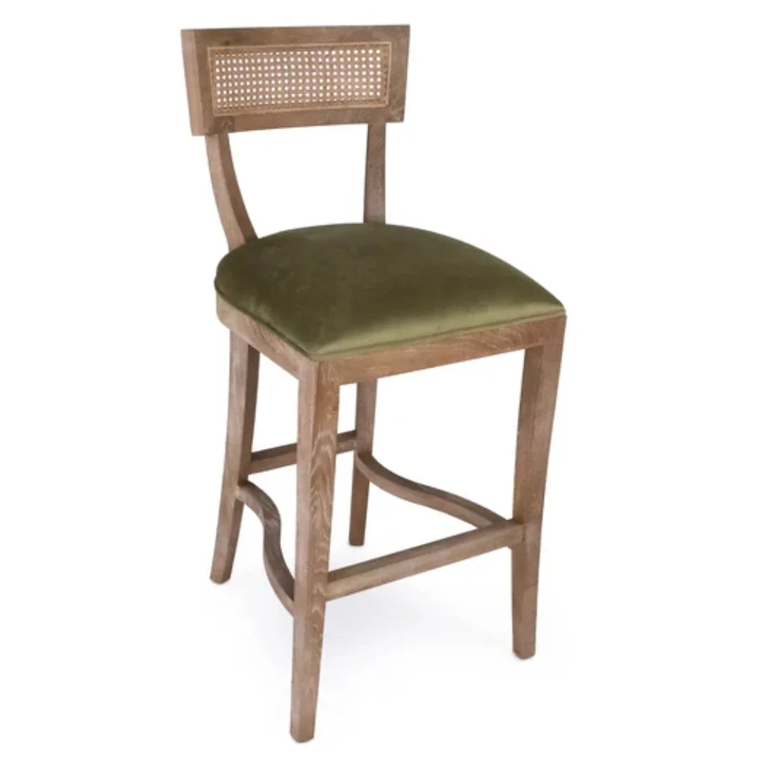 Wooden bar stool with green velvet seat and cane back panel, rustic farmhouse style