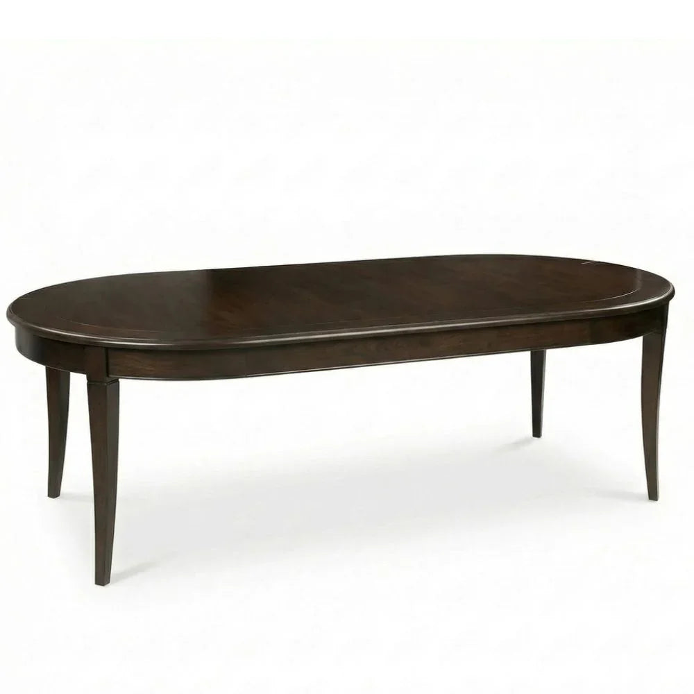 Elegant oval wooden dining table in dark finish, perfect for farmhouse or French country decor