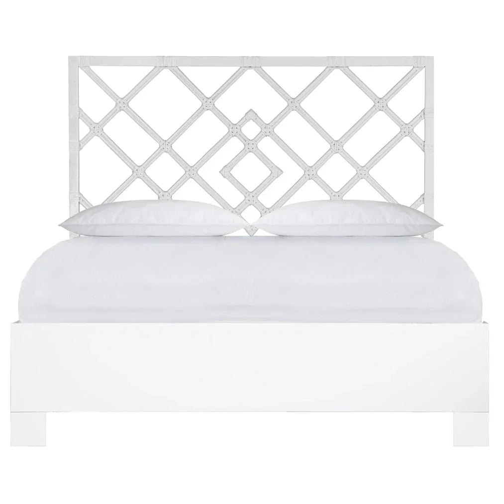 White lattice headboard bed in coastal or farmhouse style with clean lines and soft pillows