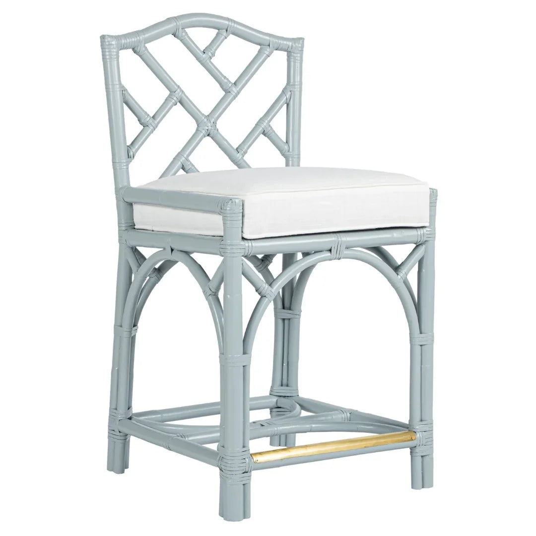 Light gray rattan bar stool with white cushion and gold footrest, coastal farmhouse style