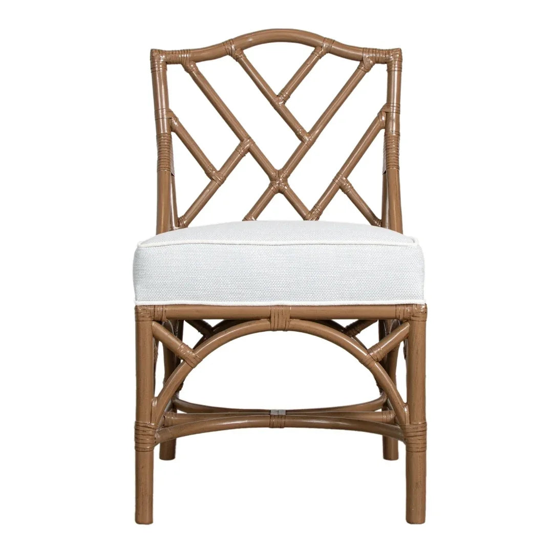 Coastal-style rattan dining chair with white cushion, natural boho aesthetic