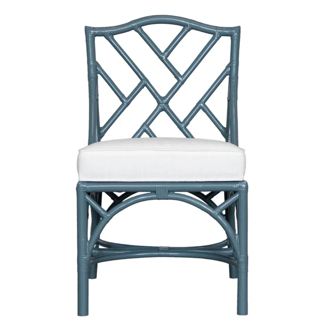 Blue rattan dining chair with white cushion, coastal farmhouse style