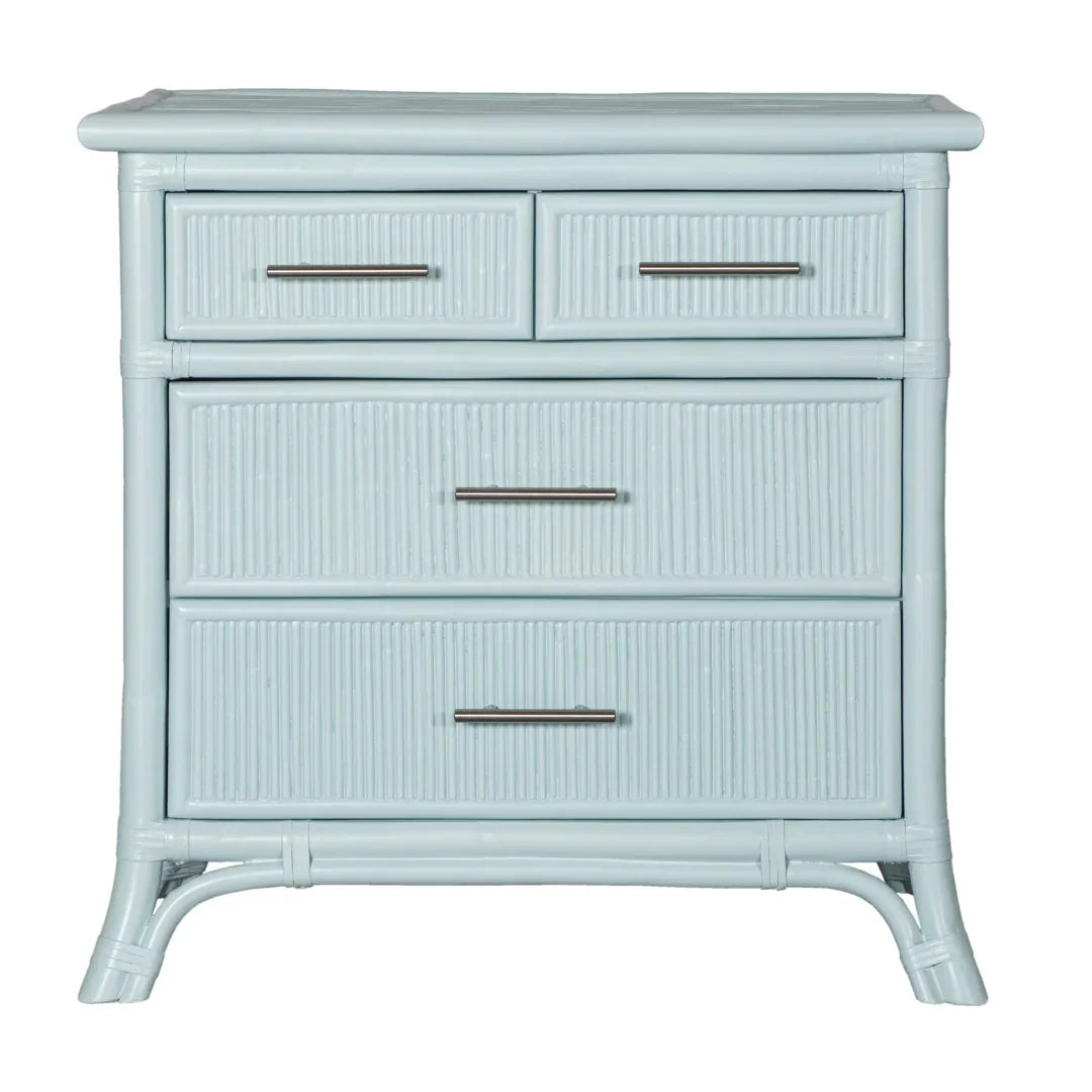 Light blue rattan dresser with four drawers, coastal style, metal handles, and curved legs