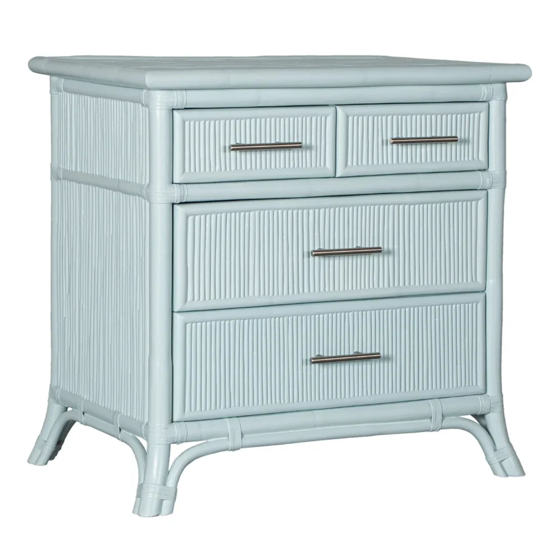 Coastal-style light blue rattan chest with four drawers and metal handles, perfect for beach house decor.