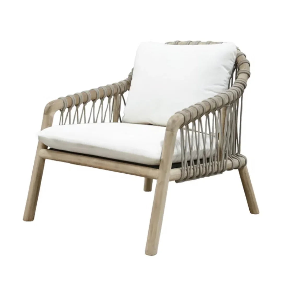 Coastal style rattan armchair with white cushions, natural wood frame, perfect for boho or farmhouse decor