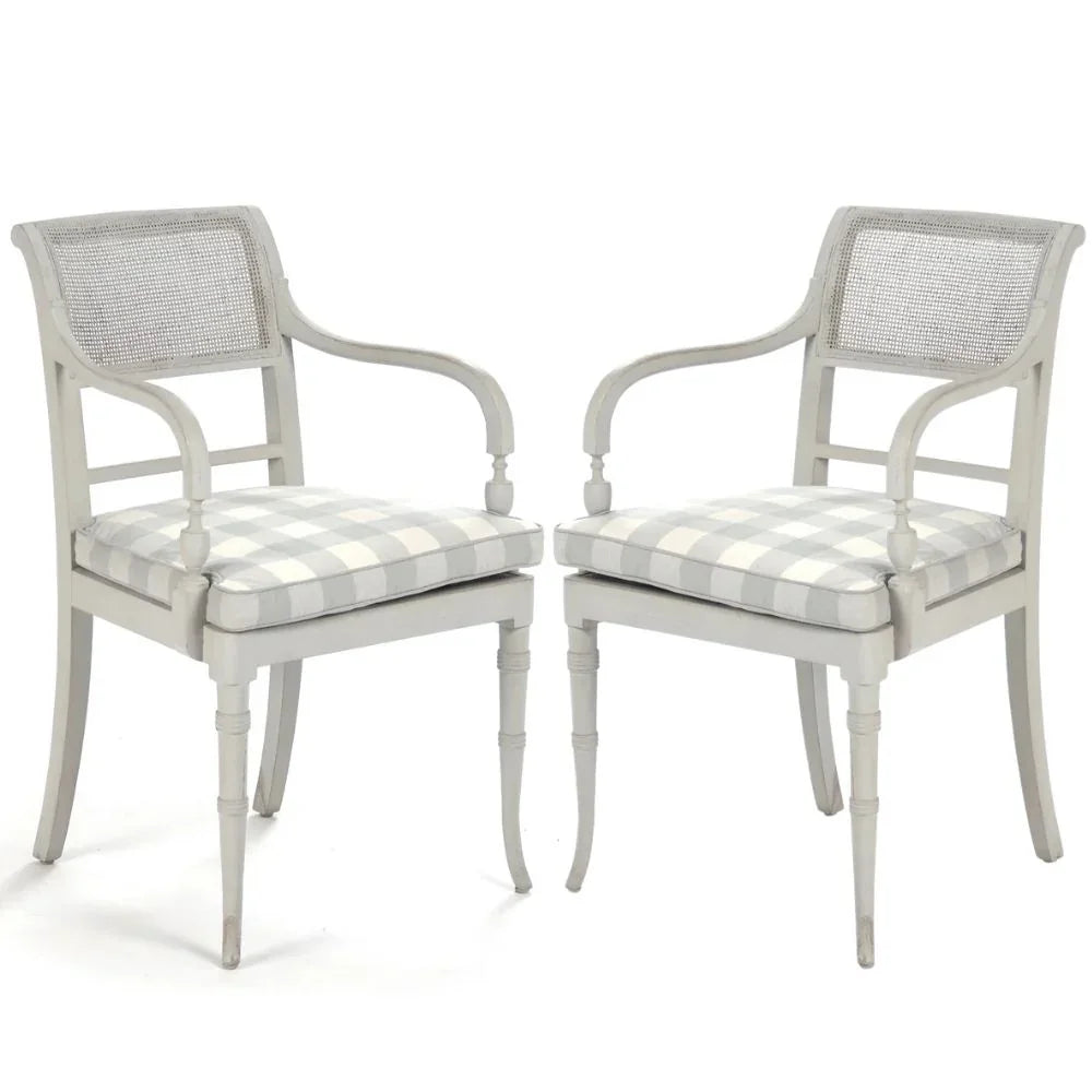 Elegant French country armchairs with cane back and gingham cushion, perfect for shabby chic or farmhouse decor.