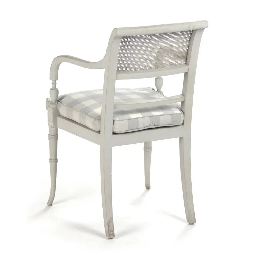 French country armchair with cane back, gray check cushion, and distressed finish