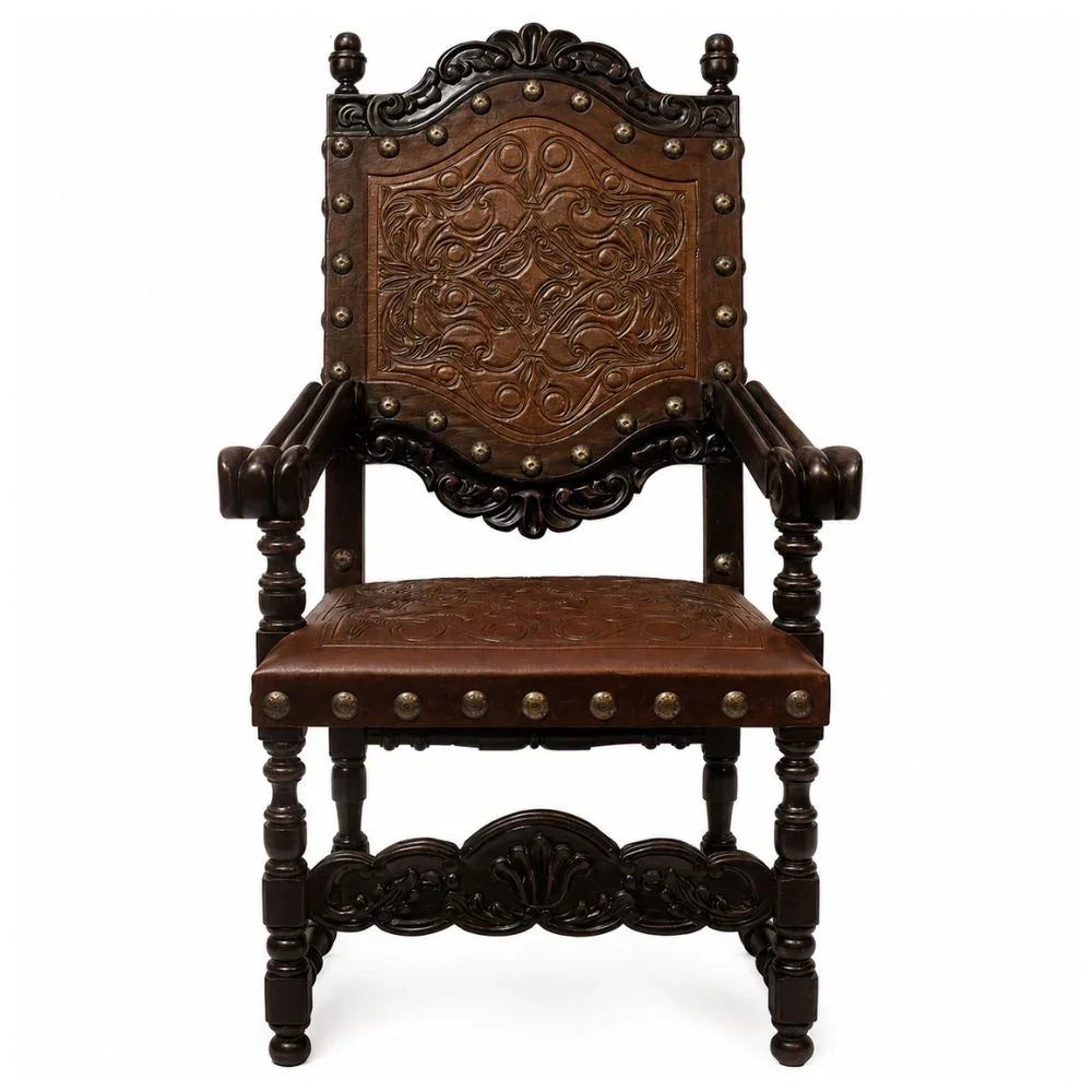 Ornate French country armchair with carved wood and studded leather upholstery