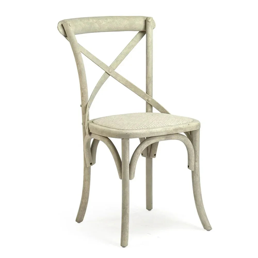 Shabby chic dining chair with crossed back, woven seat, and distressed finish in neutral tone