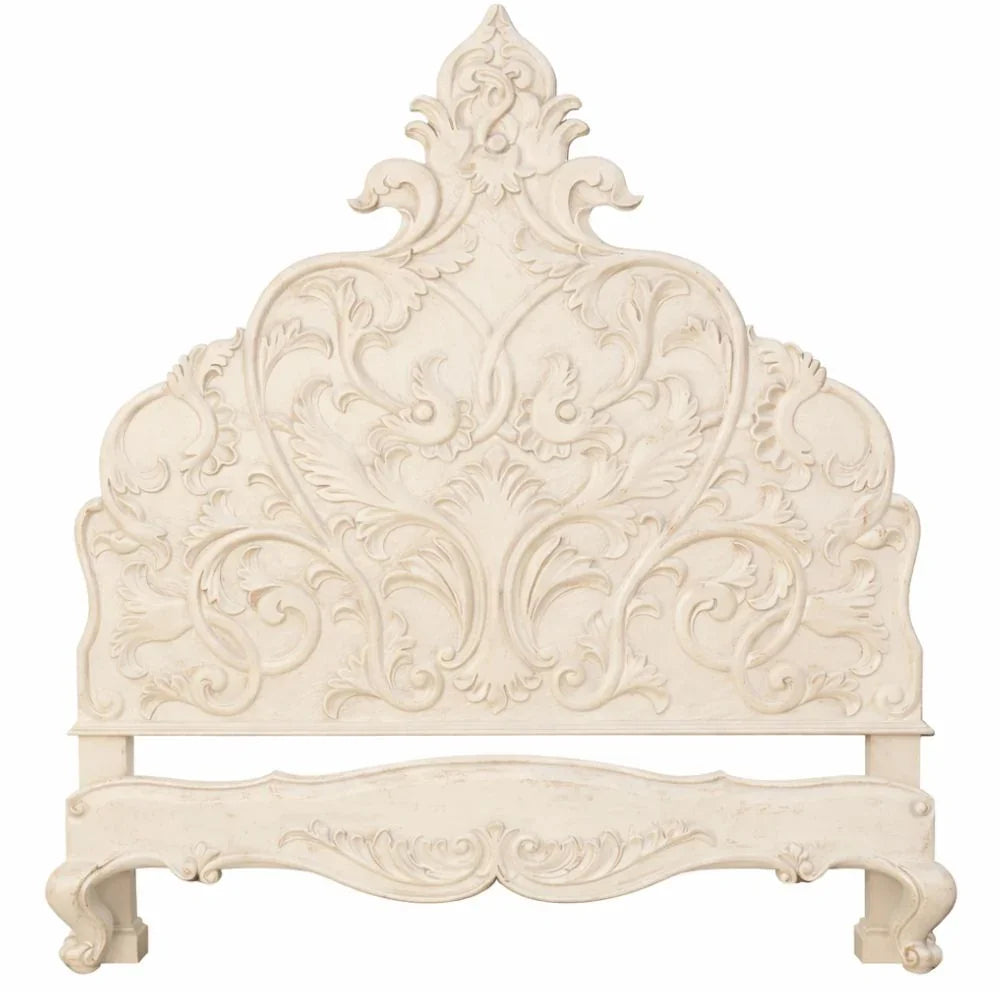Ornate French country headboard with intricate floral carvings and distressed cream finish