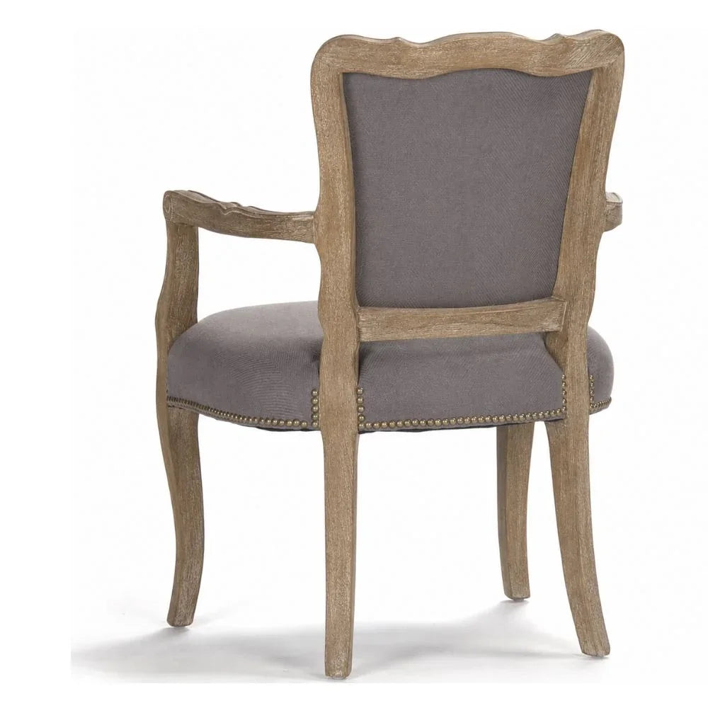 French country armchair with gray upholstery, nailhead trim, and distressed wood frame