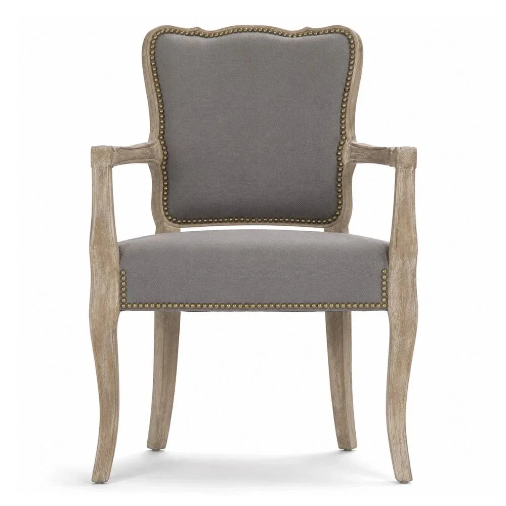 French country armchair with gray upholstery, nailhead trim, and distressed wood frame