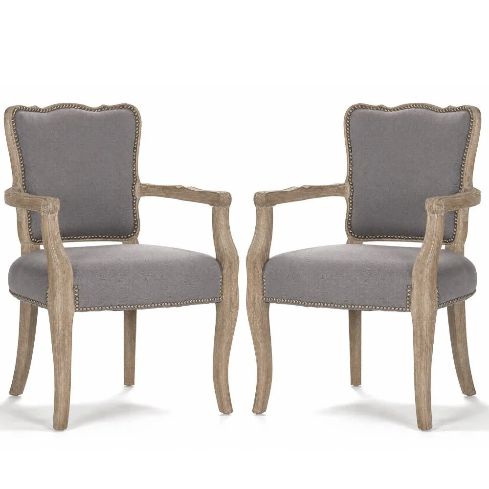 Gray upholstered armchairs with rustic wood frames and nailhead trim, French country style