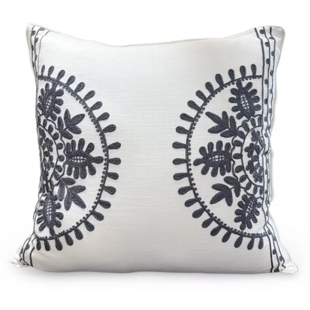 White throw pillow with navy blue floral embroidery, perfect for shabby chic or farmhouse decor
