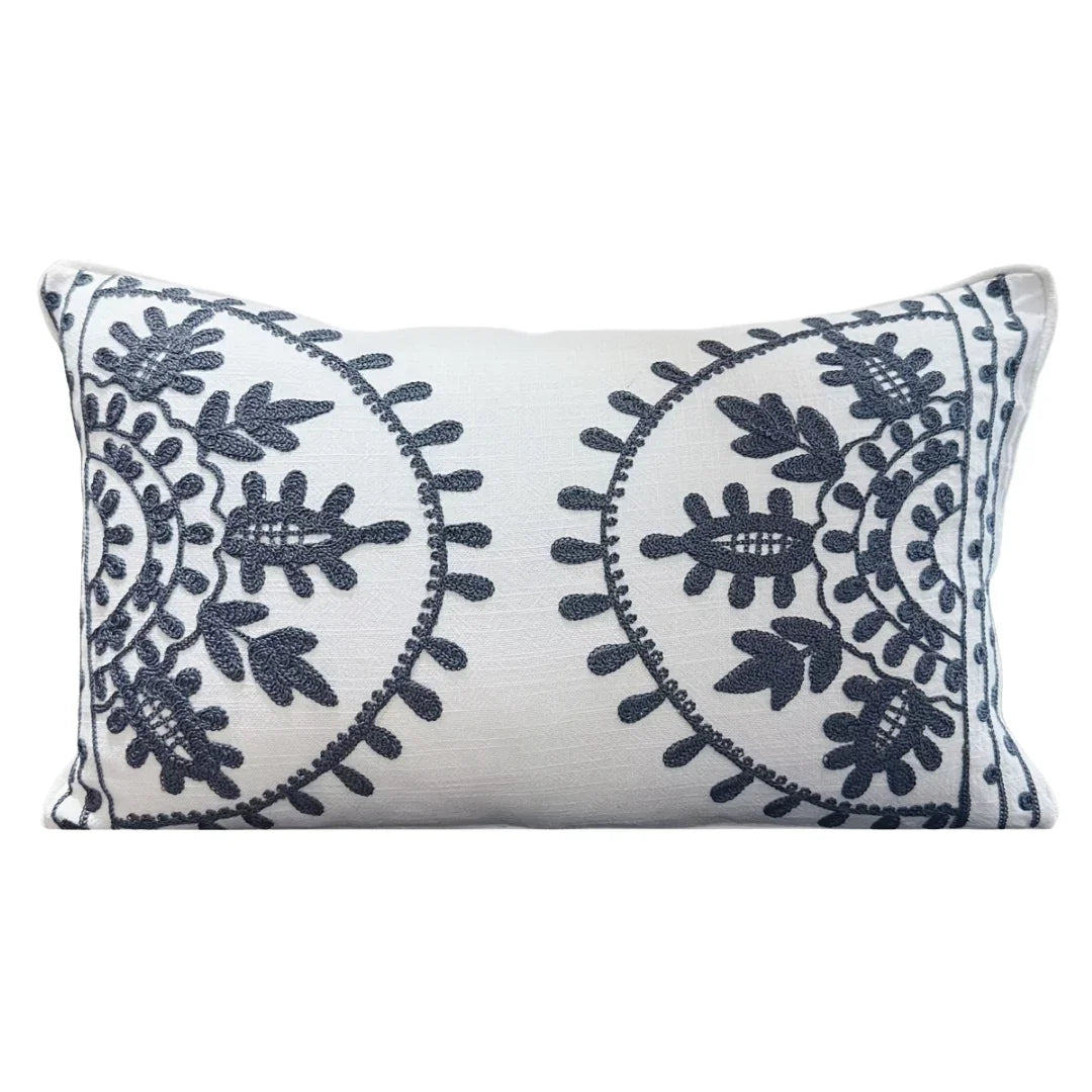 White lumbar pillow with navy blue floral embroidery, boho coastal decor accent