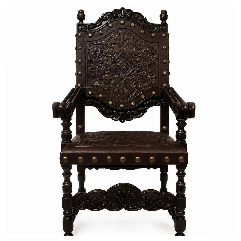 Ornate dark wood armchair with carved details and brass nailhead trim, French country style
