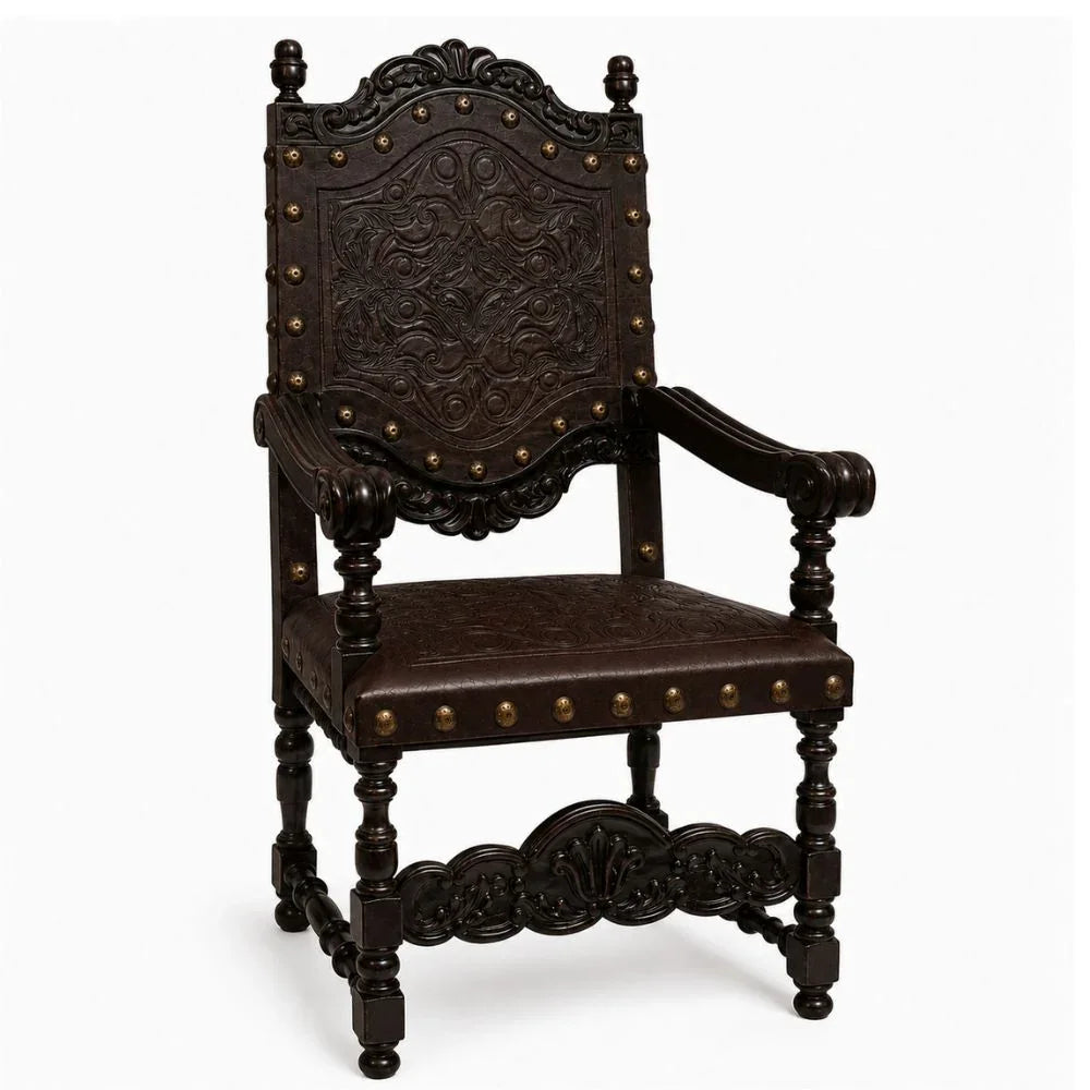 Ornate dark wood armchair with carved details and brass studs, French country style