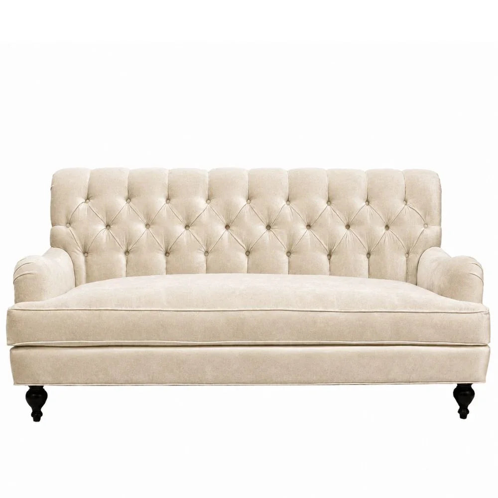 Cream tufted sofa with rolled arms and dark wood legs, French country style