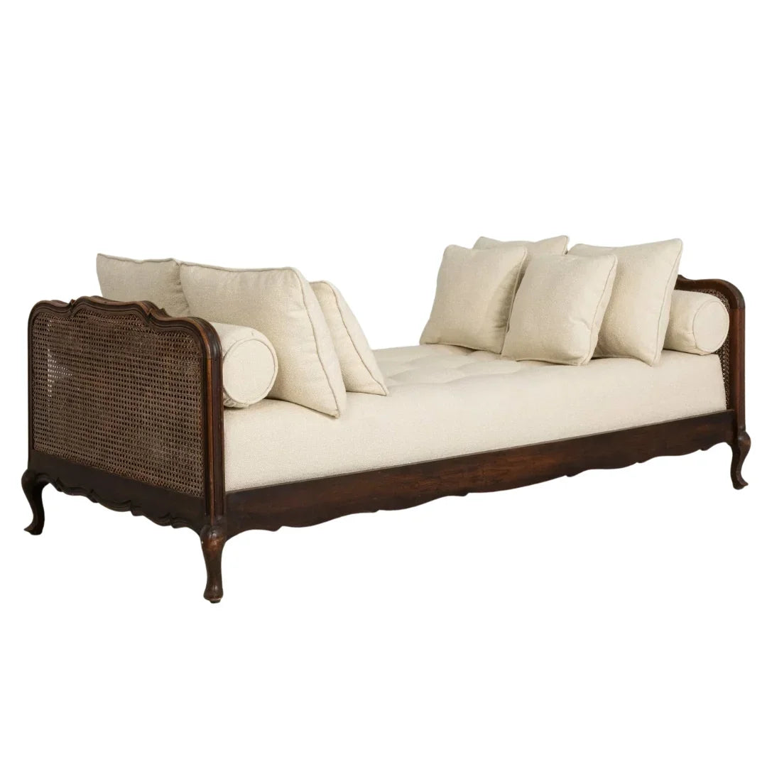 French country cane daybed with cream cushions and carved wood frame, shabby chic style