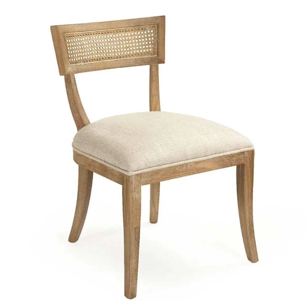 Natural boho cane back dining chair with light wood frame and linen seat cushion