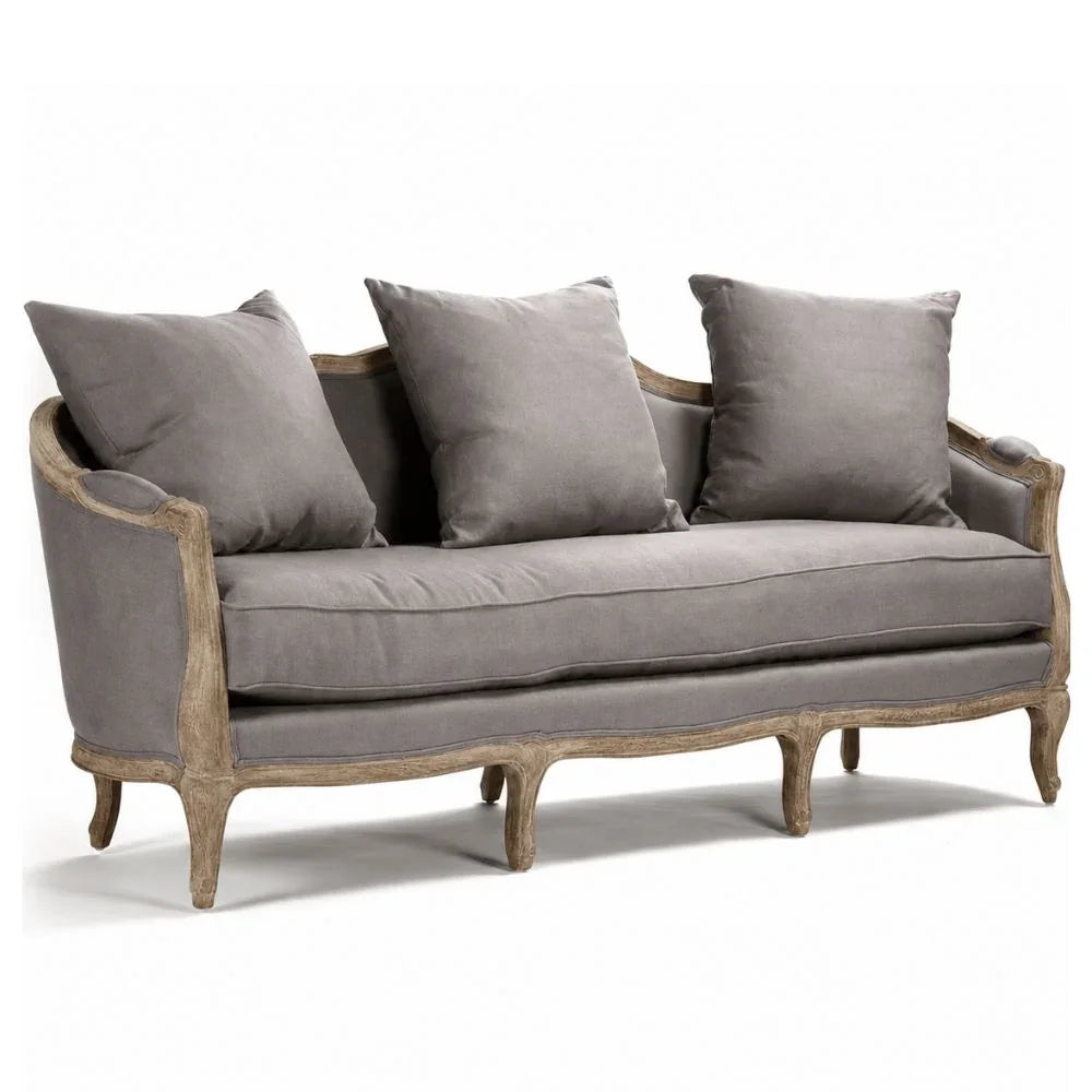 Grey French country sofa with distressed wood frame and plush cushions, perfect for shabby chic or farmhouse decor