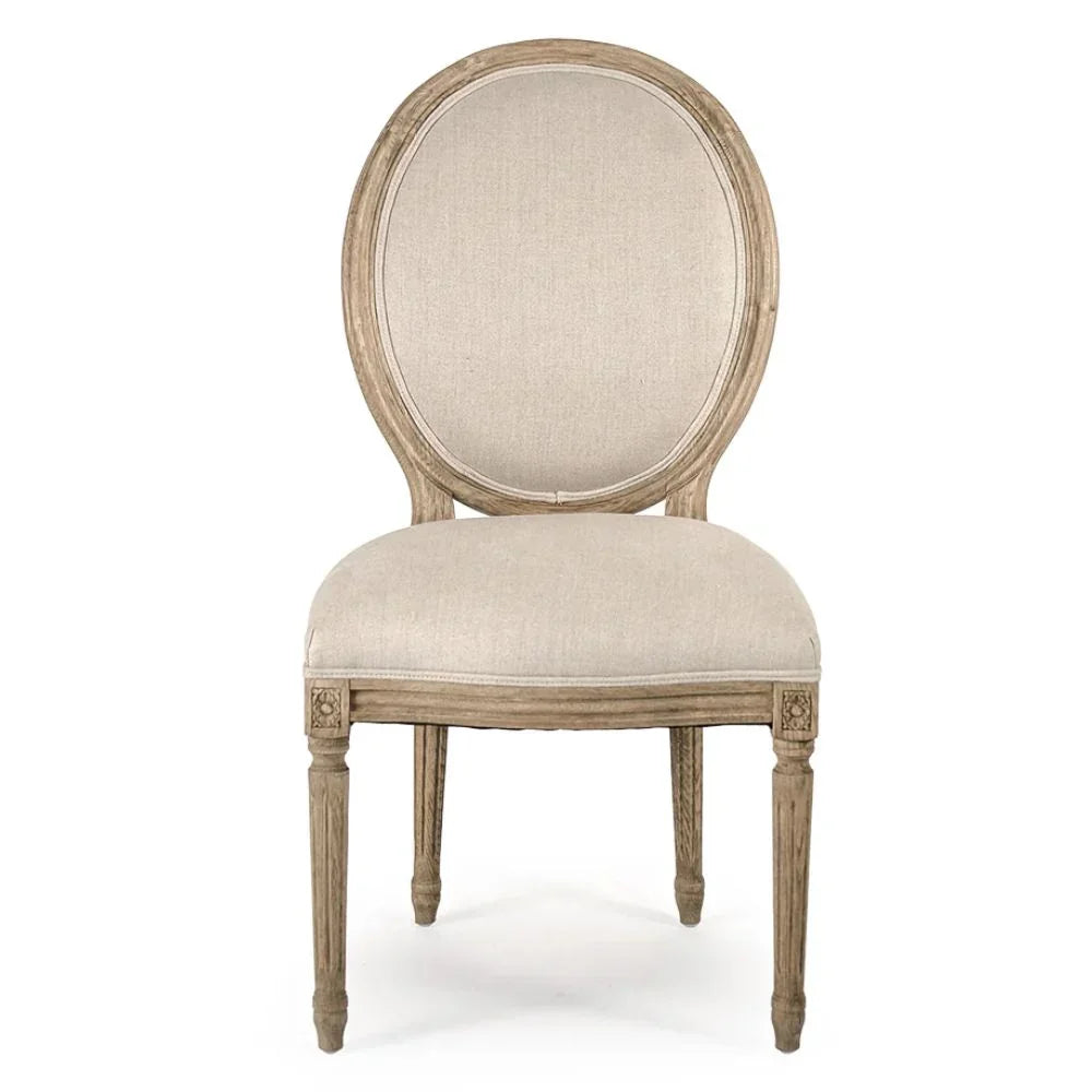 Elegant French country dining chair with oval back, linen upholstery, and distressed wood finish