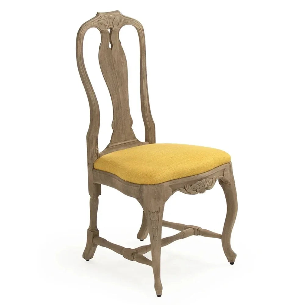 French country dining chair with yellow upholstered seat and carved wood details