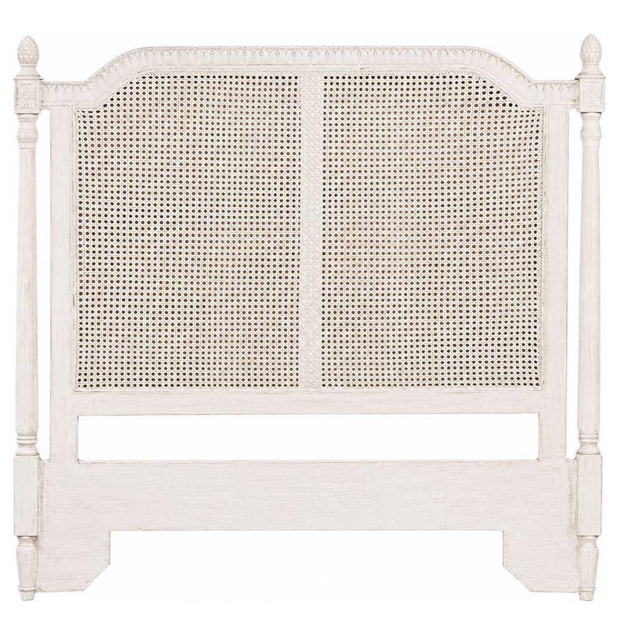 White distressed cane headboard in French country shabby chic style with turned posts