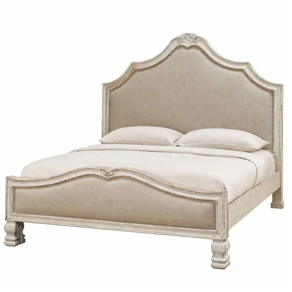 Elegant French country bed with distressed finish, curved headboard, and upholstered panels in neutral tones