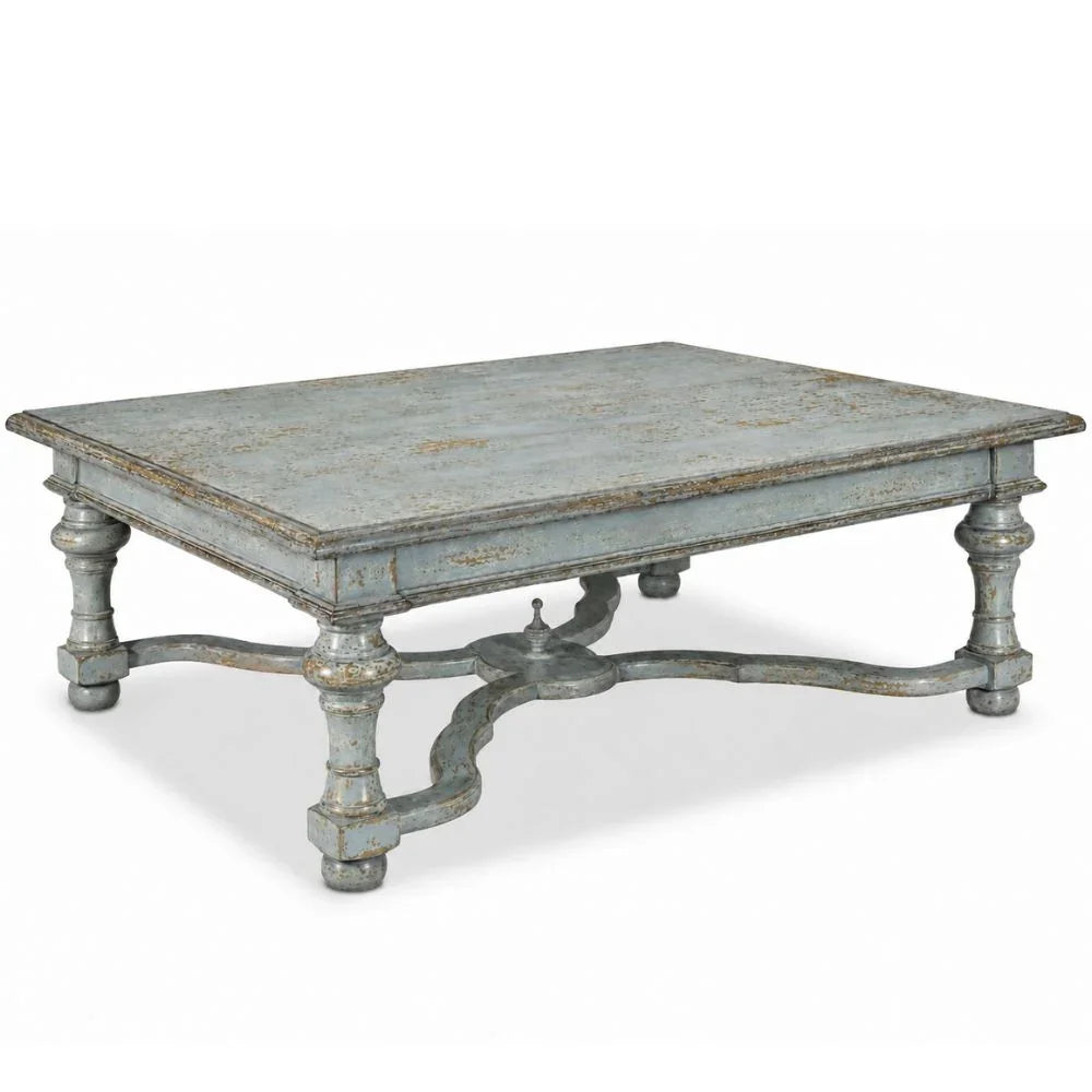 Distressed light blue French country coffee with a curvy cross stretcher with a center finial