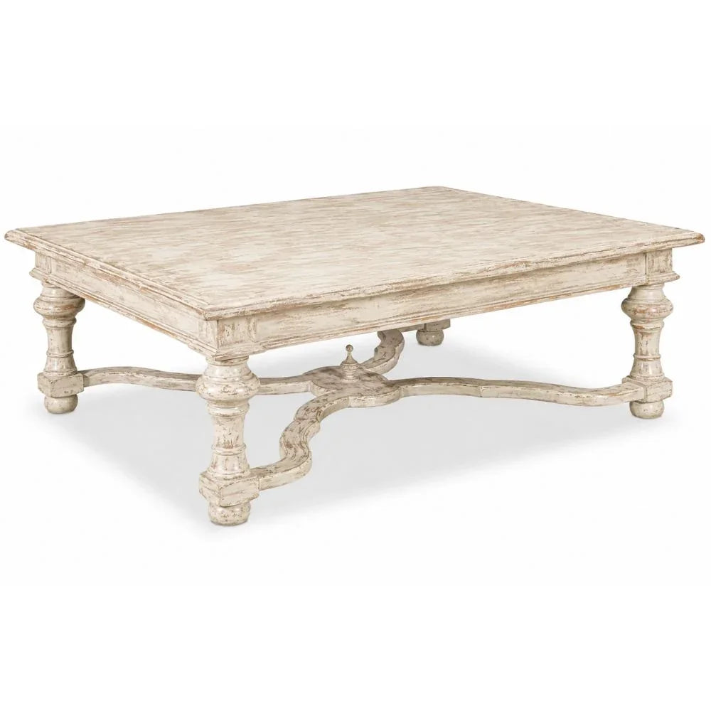 Distressed white French country coffee table with ornate legs and rustic charm